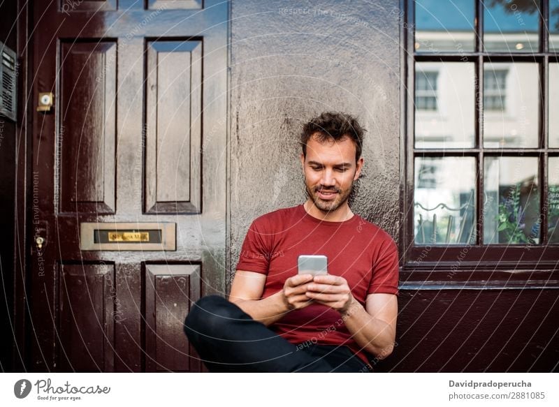 Man sitting in a bench on a beautiful maroon background Cellphone Caucasian Cheerful Building Youth (Young adults) Architecture Technology Vintage Smiling