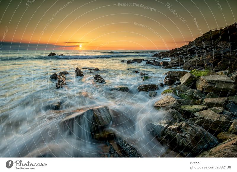 Long time exposure of water surrounded rocks in the sea with sunset Rock Deep depth of field Evening Long exposure Sunset Sunrise Sunlight Contrast Deserted