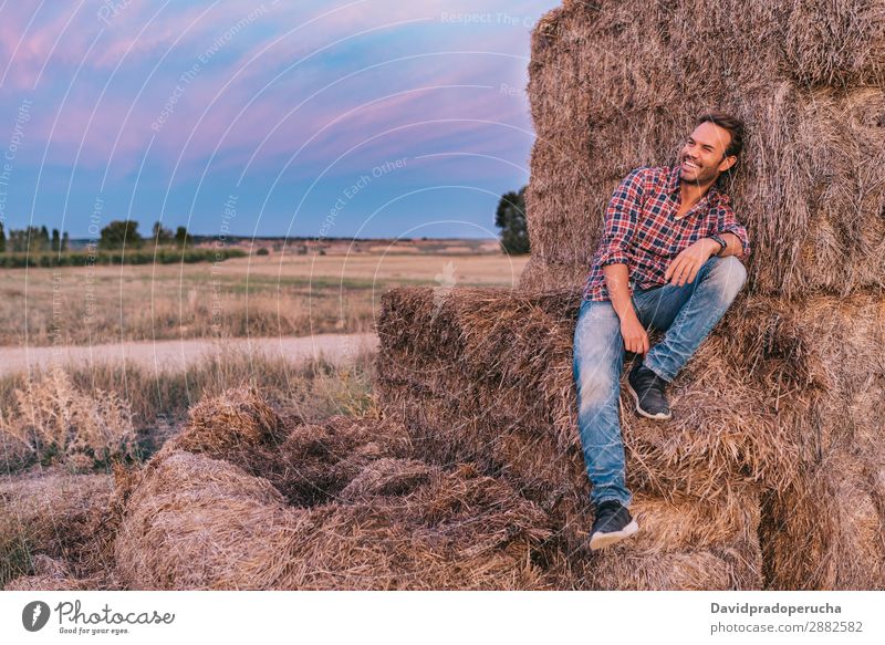 Happy man sitting on a pile of hay Man Farmer Hay Summer Caucasian Landscape Nature Countries Sky Relaxation Lifestyle Work and employment Seasons Exterior shot