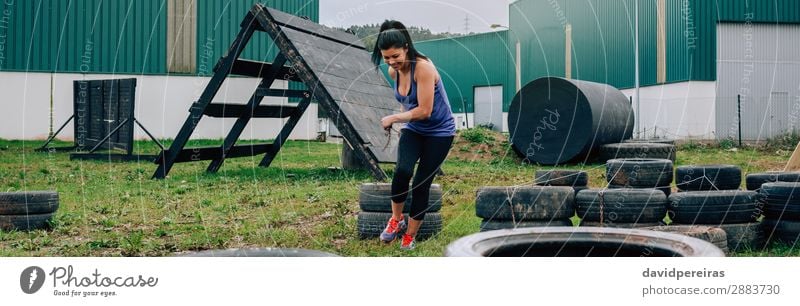 Woman in obstacle course dragging wheels Joy Happy Sports Internet Human being Adults Grass Smiling Authentic Strong Power Loneliness Effort panorama