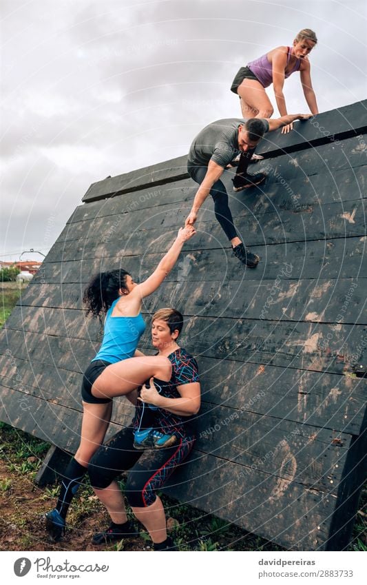 Participants in obstacle course climbing pyramid obstacle a Royalty