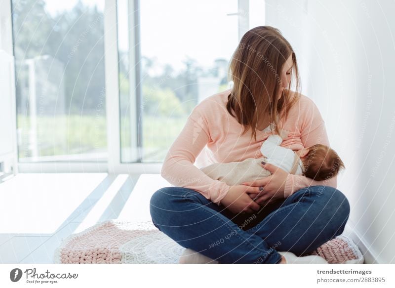 Young Mother breastfeeding newborn baby Eating Happy Beautiful Child Baby Woman Adults Parents Family & Relations Infancy Arm Feeding Love Small White