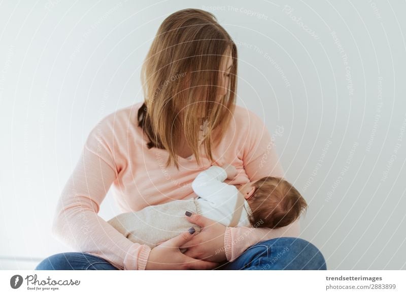 Young Mother breastfeeding newborn baby at home Eating Happy Beautiful Child Baby Woman Adults Parents Family & Relations Infancy Arm Feeding Love Small White