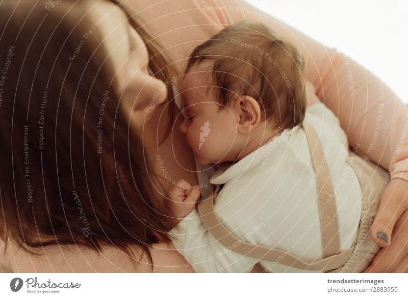 Young Mother holding newborn baby in arms Eating Happy Beautiful Child Baby Woman Adults Parents Family & Relations Infancy Arm Feeding Love Small White