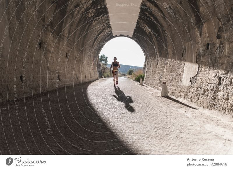 Runner in tunnel Lifestyle Happy Sports Human being Woman Adults 1 Nature Park Brunette Fitness young people healthy fit Beauty Photography athlete workout