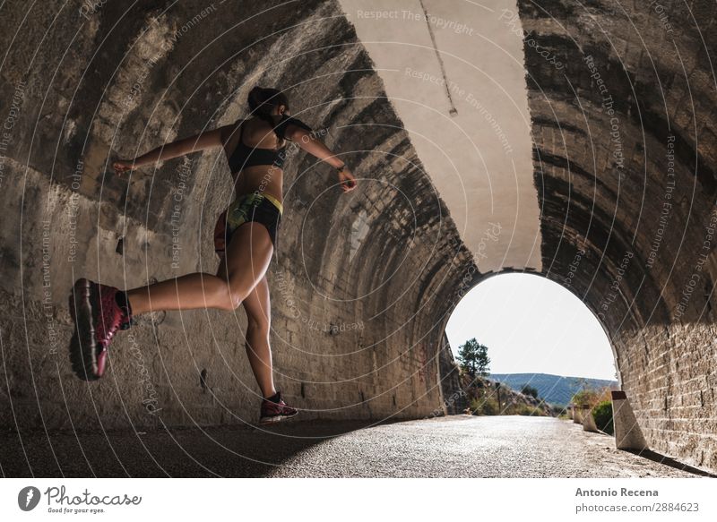 Runner and tunnel Lifestyle Sports Human being Woman Adults 18 - 30 years Youth (Young adults) Nature Brunette Running Jump young people healthy fit