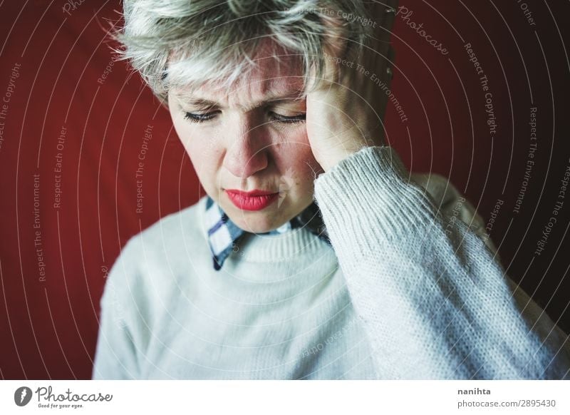 Middle age woman suffering pain - a Royalty Free Stock Photo from Photocase