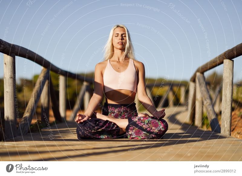 Caucasian female practicing yoga on wooden bridge. Lifestyle Happy Beautiful Body Harmonious Relaxation Meditation Freedom Summer Sun Beach Yoga