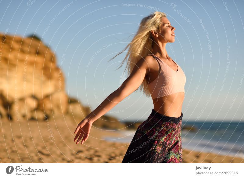 Woman enjoying the sunset on a beautiful beach Lifestyle Happy Beautiful Body Relaxation Meditation Leisure and hobbies Vacation & Travel Freedom Summer Sun