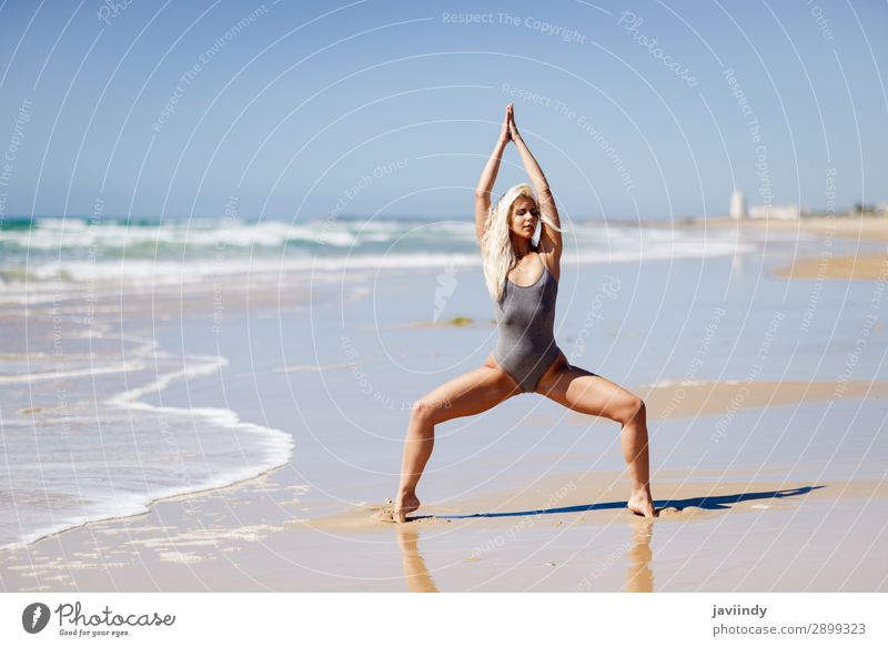 Blonde pregnant woman doing yoga at the beach Stock Photo - Alamy