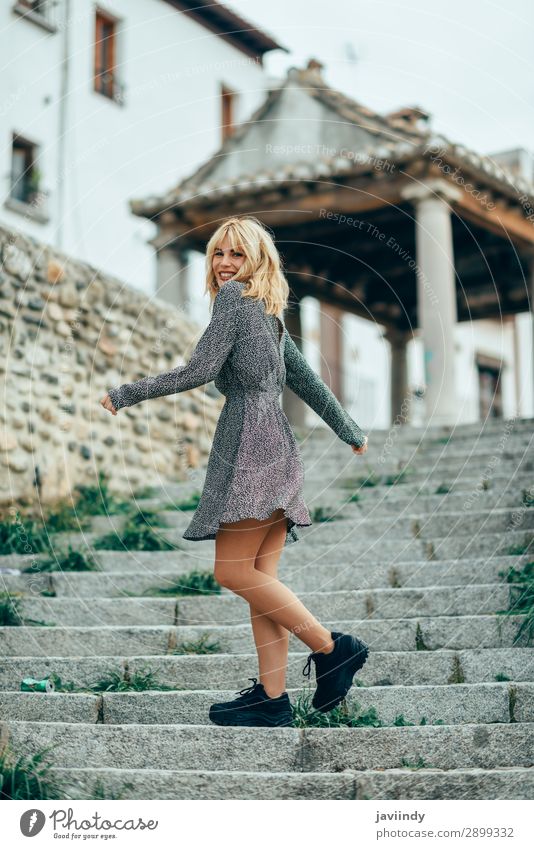 Happy young blond girl standing on urban background. Lifestyle Style Joy Beautiful Hair and hairstyles Human being Feminine Young woman Youth (Young adults)