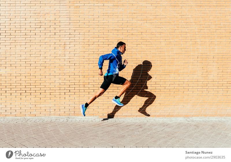 Handsome man running in the city. Man Running Jogging Runner Street City Athlete Speed Fitness Lifestyle Youth (Young adults) Town Action Shadow handsome