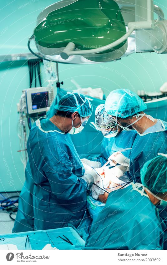 Team of Surgeons Operating. Operation Surgery operating surgical Hospital Room Doctor Theatre Medication Work and employment Group instrumental clinic Man Woman