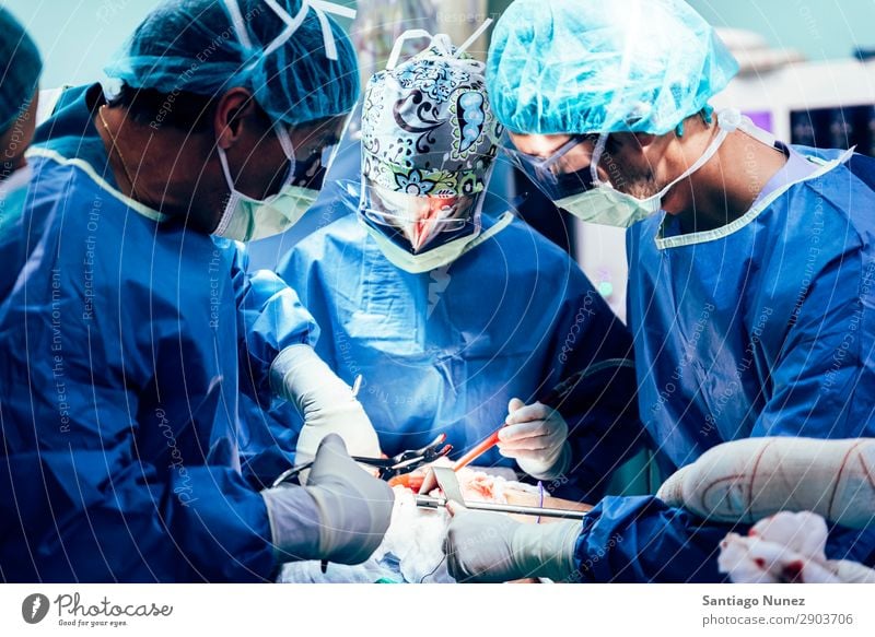 Team of Surgeons Operating. Operation Surgery operating surgical Hospital Room Doctor Theatre Medication Work and employment Group instrumental clinic Man Woman