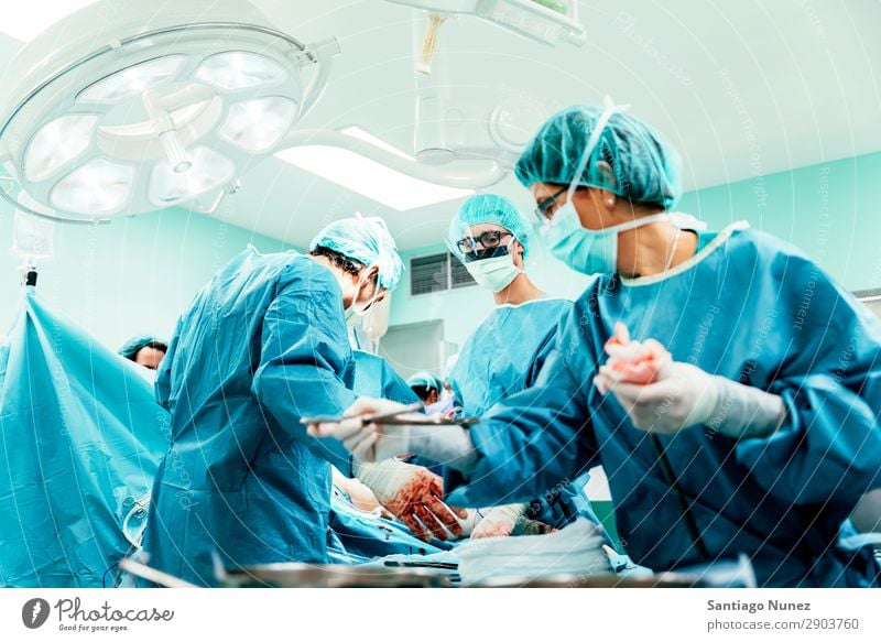 Team of Surgeons Operating. Operation Surgery operating surgical Hospital Room Doctor Theatre Medication Work and employment Group instrumental clinic Man Woman