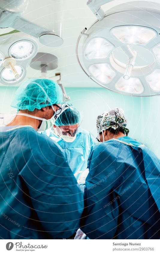 Team of Surgeons Operating. Operation Surgery operating surgical Hospital Room Doctor Theatre Medication Work and employment Group instrumental clinic Man Woman