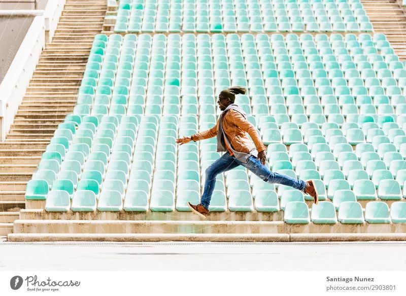 American man jumping in the park. Man Telephone Town Jump acting African Black Youth (Young adults) Human being Happy Happiness Smiling Laughter Cheerful