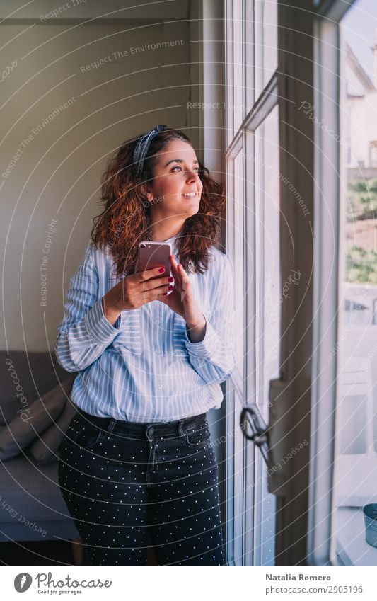Business girl looking through the window with her phone Happy Profession Workplace Office Company Telephone Cellphone PDA Human being Woman Adults