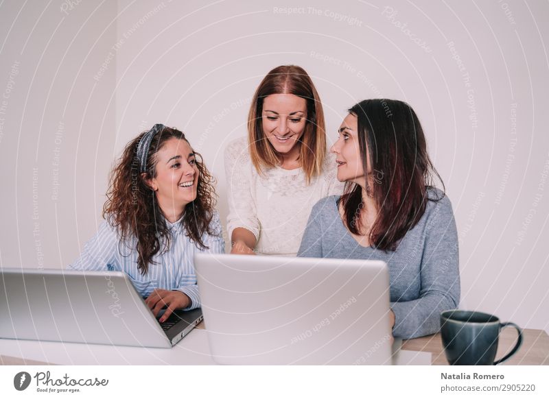 three women are laughing while working together in the office Happy Desk Work and employment Profession Workplace Office Business To talk Computer Notebook