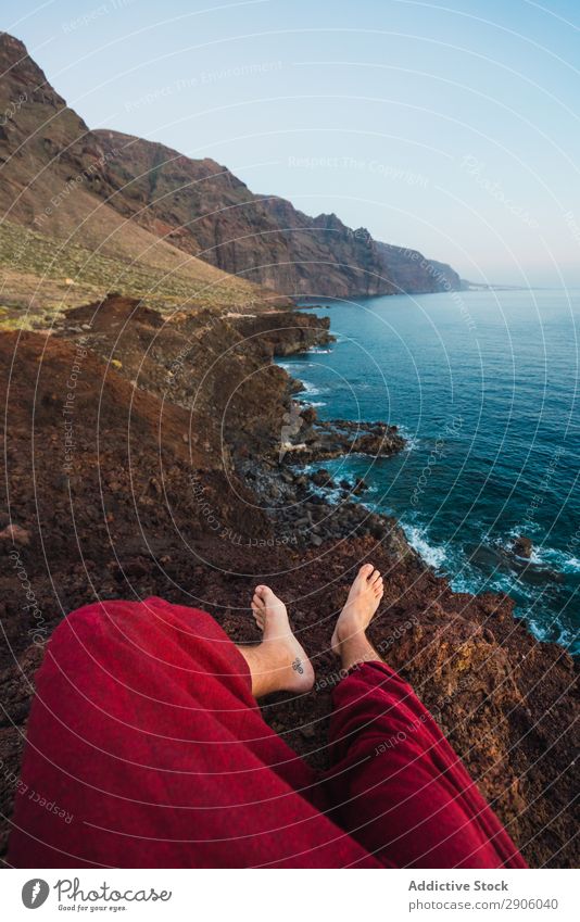 Person on stone shore near water Ocean Coast Water Mountain Teide Tenerife Canaries Spain Legs Stone Lie (Untruth) Vantage point Rock Amazing Vacation & Travel