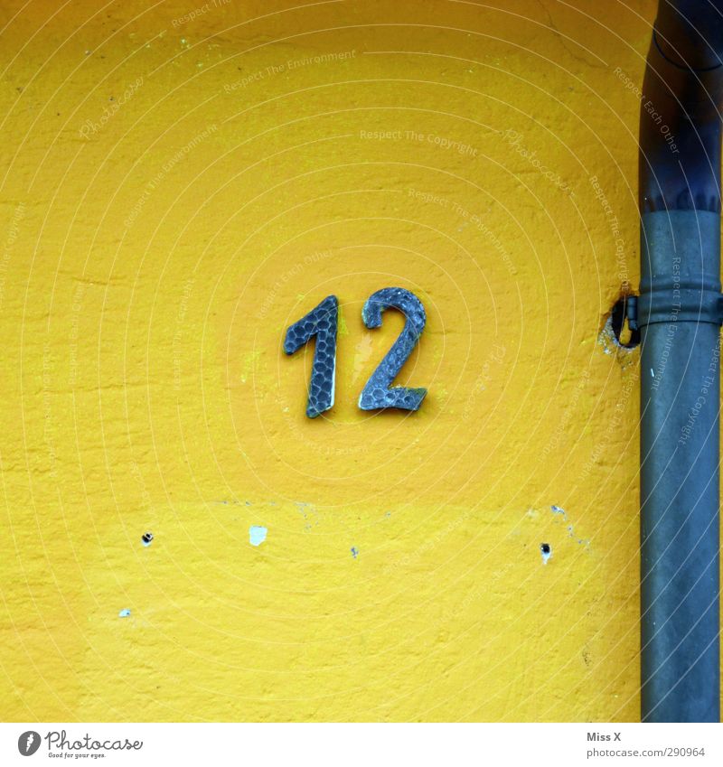 12 Sign Characters Signs and labeling Blue Yellow House (Residential Structure) Wall (building) Conduit Digits and numbers House number Colour photo