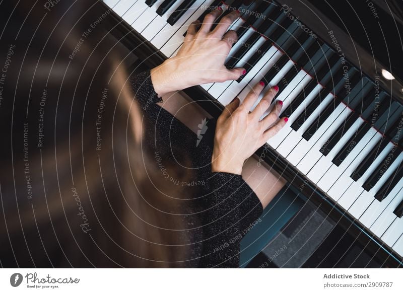 Overhead view of pianist playing piano at home - a Royalty Free Stock