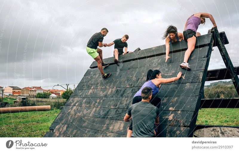 Group in obstacle course climbing pyramid Sports Climbing Mountaineering Human being Woman Adults Man Observe Authentic Strong Black Effort Competition Teamwork