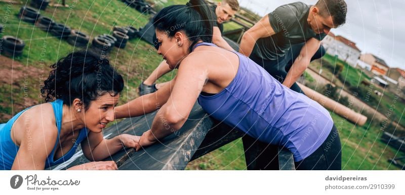 Group in obstacle course climbing pyramid Sports Climbing Mountaineering Internet Human being Woman Adults Man Authentic Strong Effort Competition Teamwork