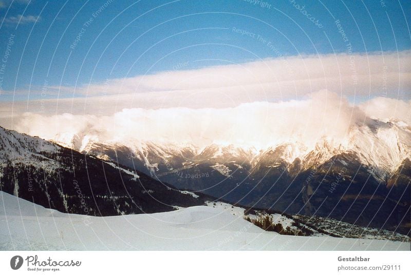 The mountain calls_1 Mountain range Switzerland Winter Cold Clouds Alps Snow Vantage point Tall Blue sky clear vision
