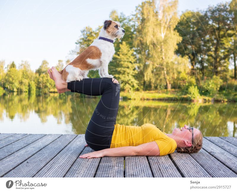 Young woman doing yoga with dog Lifestyle Fitness Leisure and hobbies Summer Yoga Feminine Youth (Young adults) 1 Human being 18 - 30 years Adults Water Sky