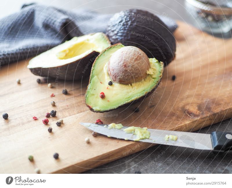 https://www.photocase.com/photos/2915764-avocado-with-core-on-a-wooden-board-food-vegetable-photocase-stock-photo-large.jpeg