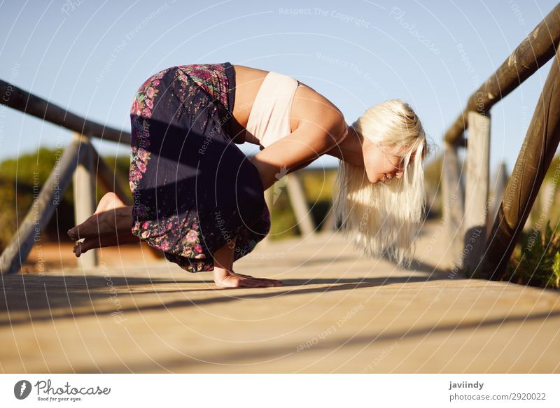 Caucasian female practicing yoga on wooden bridge. Lifestyle Happy Beautiful Body Harmonious Relaxation Meditation Freedom Summer Sun Beach Yoga