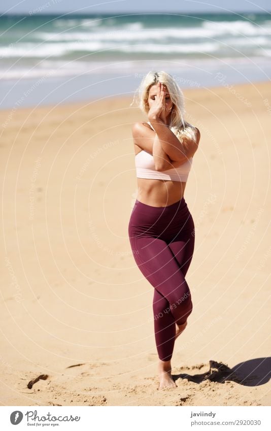 Caucasian blonde woman practicing yoga in the beach Lifestyle Beautiful Body Harmonious Relaxation Meditation Summer Beach Ocean Sports Yoga Human being