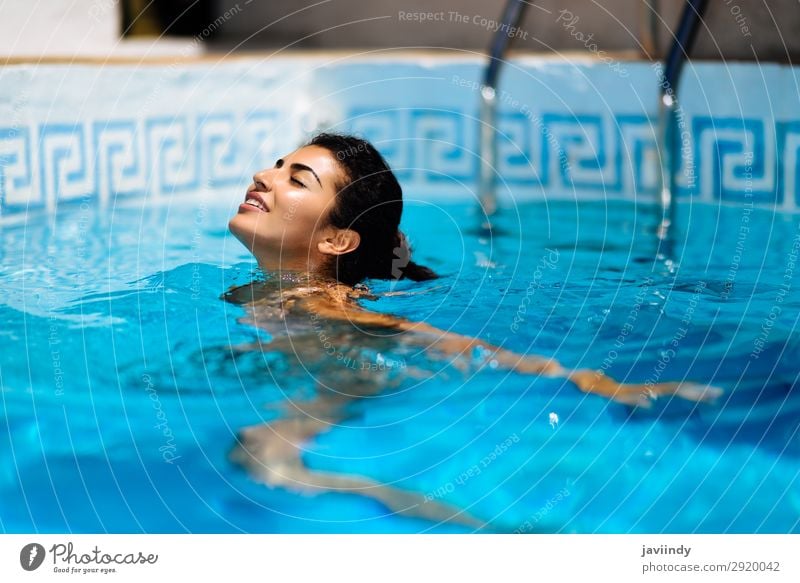 Beautiful tanned woman in bikini relaxing in swimming pool Lifestyle Happy Body Hair and hairstyles Skin Relaxation Swimming pool Leisure and hobbies