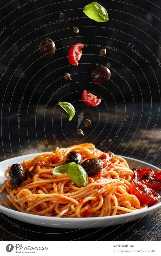 Spaghetti with tomato sauce olives and capers Vegetable Lunch Dinner Vegetarian diet Plate Wood Green Red Tradition pasta puttanesca Olive Basil Tomato Sauce