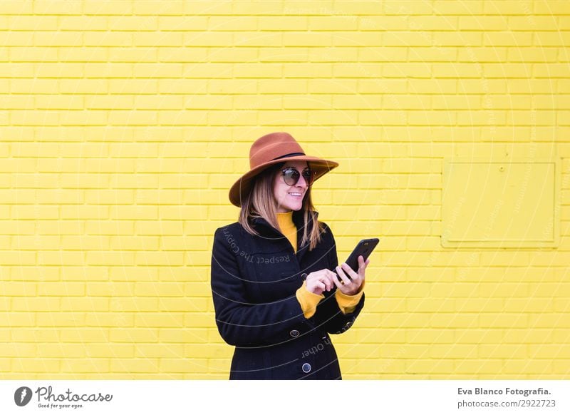 young woman outdoors using mobile phone and smiling Lifestyle Style Happy Beautiful Hair and hairstyles Telephone PDA Technology Human being Feminine