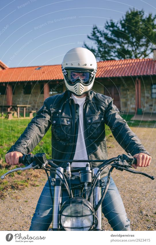 Man with helmet riding custom motorbike Lifestyle House (Residential Structure) Engines Human being Adults Tree Grass Transport Lanes & trails Vehicle