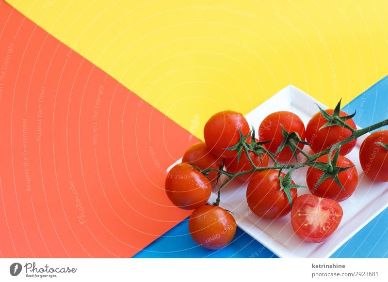 Cherry Tomatoes On A Blue Yellow And Coral Red Background A Royalty Free Stock Photo From Photocase