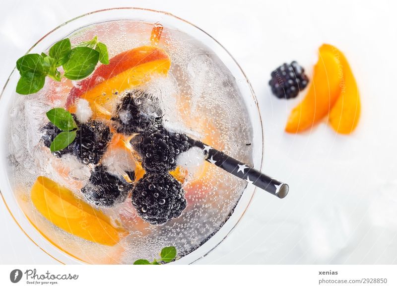 Delicious iced soft drink with blackberry and nectarine, decorated with oregano and a black drinking straw Beverage Cold drink Fruit Nectarine Herbs and spices