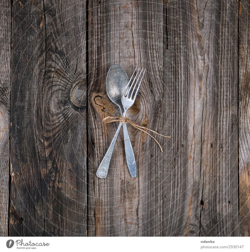 old metal fork and spoon tied with a brown rope Dinner Cutlery Fork Spoon Table Kitchen Restaurant Rope Wood Metal Old Gray Set food Rustic silverware vintage