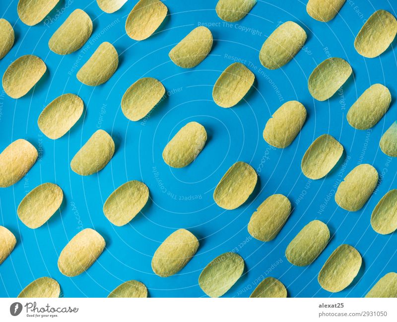 Potato chips pattern on blue background Food Eating Fast food Delicious Blue Yellow Gold calories Token Crisps crispy Crunchy Cut fast fat Frying Heap isolated