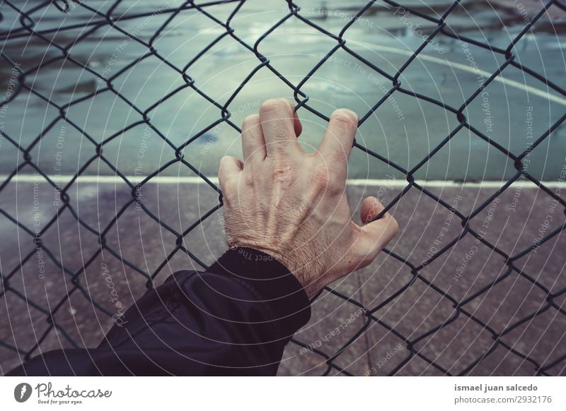 hand grabbing a metallic fence in the street Hand Man Human being Fingers Body Arm Fence Metal Street Exterior shot