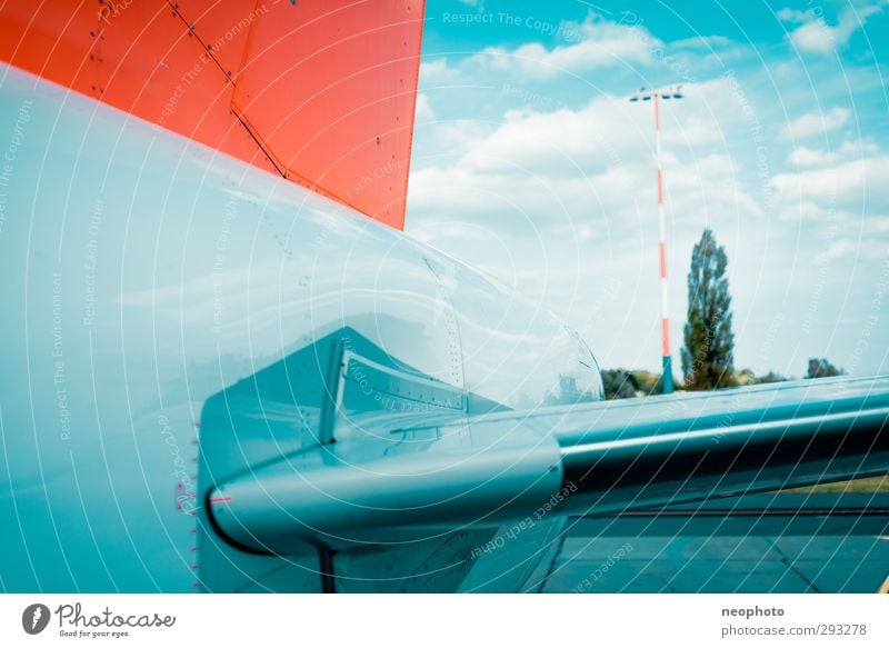 outboard Means of transport Aviation Airplane Passenger plane Airport Airfield Runway Blue Orange Sky Clouds elevator Tail Tree Colour photo Multicoloured