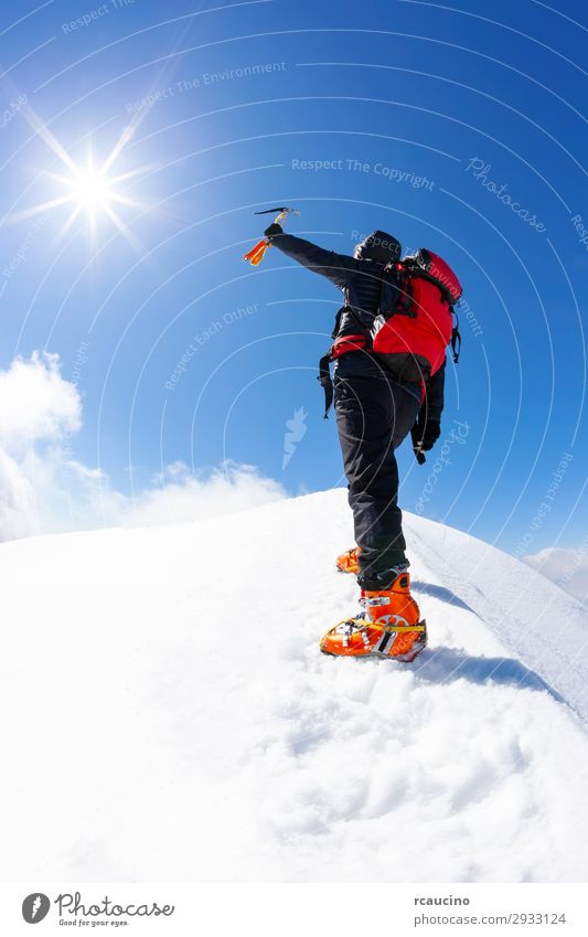 Climber reaches the summit of a snowy mountain Joy Vacation & Travel Adventure Freedom Expedition Sun Winter Snow Mountain Hiking Sports Climbing Mountaineering