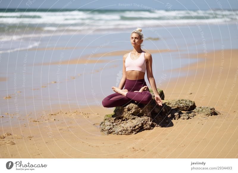 Caucasian blonde woman practicing yoga in the beach - a Royalty Free Stock  Photo from Photocase