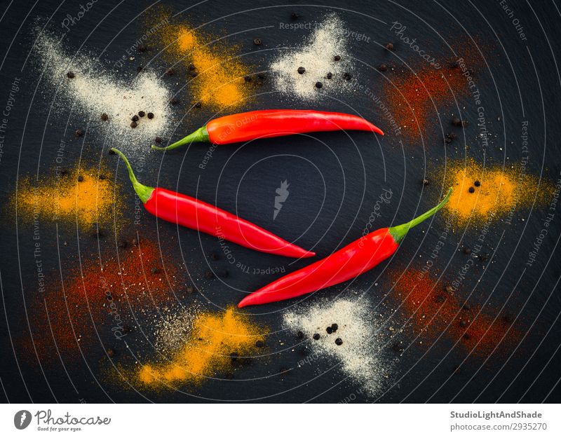 Hot pepper seasoning on dark background Vegetable Herbs and spices Eating Vegetarian diet Healthy Eating Dark Cold Natural Green Red Black White Colour peppers