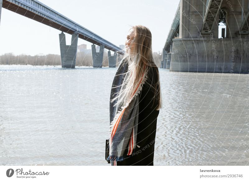 portrait of female on a beach with flying hair Vacation & Travel Blonde City Bridge Beach Cold Hair Weather Scarf Coat Spring Lifestyle Summer Ocean Young woman