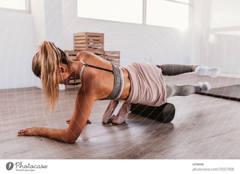Woman using foam roller in the gym Lifestyle Style Beautiful Body Sports Yoga Adults Fitness Sit Athletic Thin Bright Power Concentrate fasciae Practice Home up