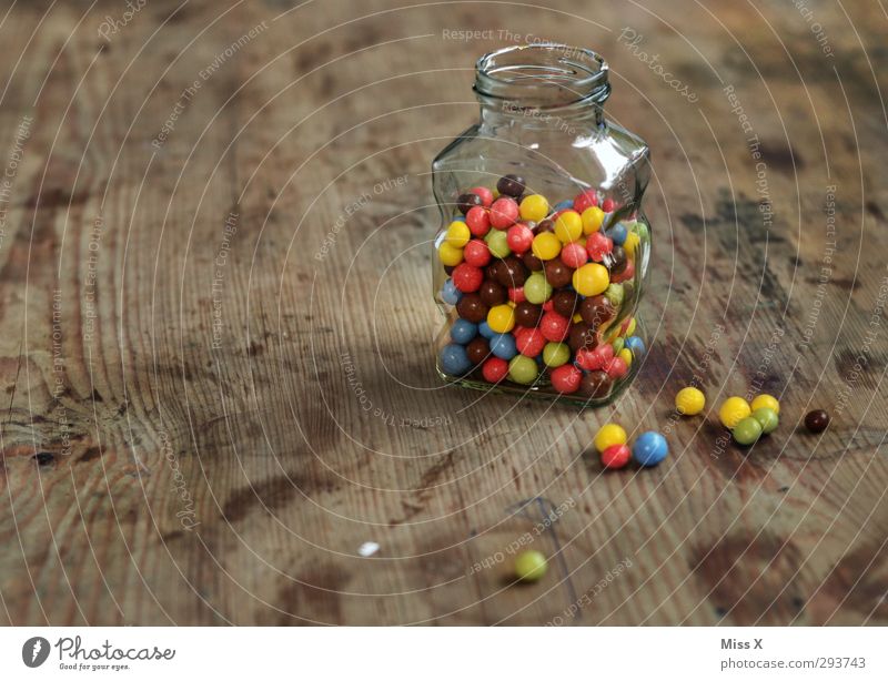 candy jar Food Candy Chocolate Nutrition Small Delicious Round Sweet Multicoloured Chocolate buttons Wooden table Glass Containers and vessels Keep Ingredients