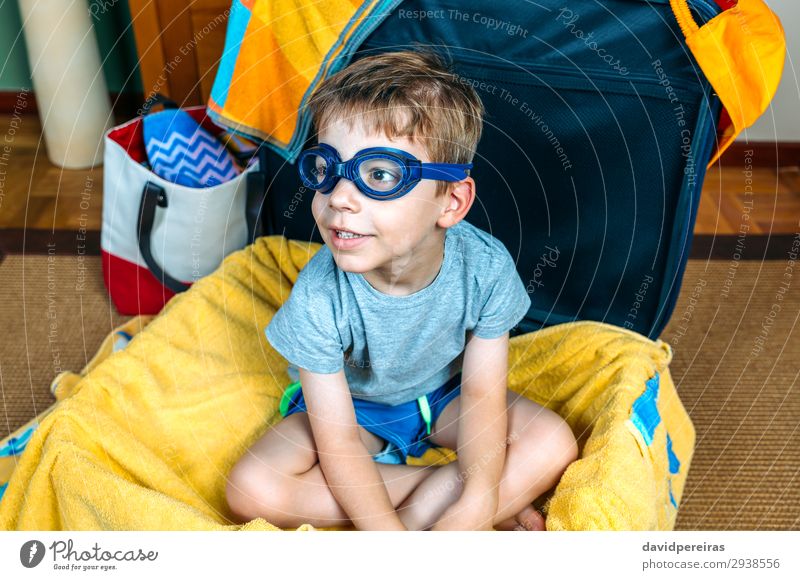 Funny boy smiling sitting inside a suitcase Lifestyle Joy Swimming pool Leisure and hobbies Vacation & Travel Trip Summer Beach Child Human being Boy (child)